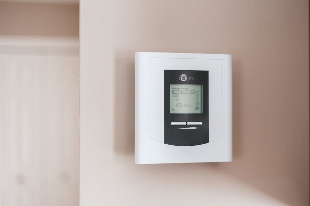 a white thermostat on the wall
